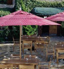 8 foot wood market umbrellas with teak chairs and teak chairs in outdoor restaurant patio setting