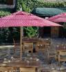 8 foot wood market umbrellas with teak chairs and teak chairs in outdoor restaurant patio setting